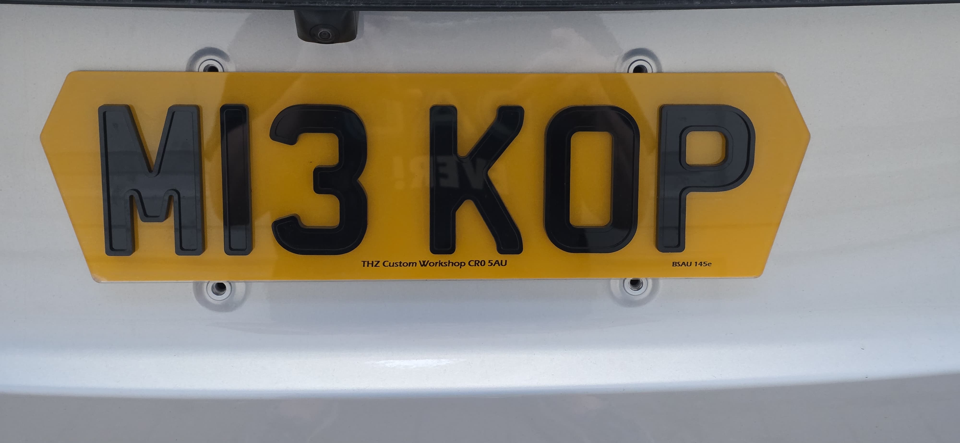 Yellow Jaecoo license plate with black text on a white background